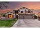Stunning two-story home featuring stone accents, a three-car garage, and well-maintained landscaping at 7029 E Monte Cir, Mesa, AZ 85209