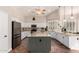 Open kitchen featuring white cabinets, an island with bar seating, granite countertops, and stainless steel appliances at 7029 E Monte Cir, Mesa, AZ 85209