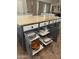 Spacious kitchen island featuring granite countertops, ample storage, and convenient pull-out wire baskets at 7029 E Monte Cir, Mesa, AZ 85209