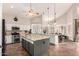 Large open kitchen featuring vaulted ceilings, white and gray cabinets, granite countertops, and stainless steel appliances at 7029 E Monte Cir, Mesa, AZ 85209