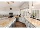 Kitchen showcasing granite countertops, white cabinetry, stainless steel appliances, and an island with breakfast bar at 7029 E Monte Cir, Mesa, AZ 85209