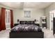 Well-lit bedroom features a black bed frame, matching nightstands, carpet floors, and generous natural light at 7029 E Monte Cir, Mesa, AZ 85209