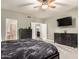 Spacious primary bedroom with dual dressers, carpet, flat-screen television, and ensuite bathroom entry at 7029 E Monte Cir, Mesa, AZ 85209