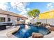 Inviting pool area with natural rock features, and ample seating for relaxation and entertaining at 7029 E Monte Cir, Mesa, AZ 85209