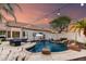 Backyard pool with waterfall feature, outdoor seating, and lush landscaping for a relaxing oasis at 7029 E Monte Cir, Mesa, AZ 85209