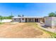 View of the house with fountain in backyard needing some TLC on a sunny day at 7047 W Almeria Rd, Phoenix, AZ 85035