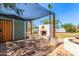 Covered backyard patio with an outdoor fireplace, fountain, and a desert landscape at 7047 W Almeria Rd, Phoenix, AZ 85035