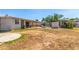 Backyard view including covered patio, outdoor fireplace, fountain, and desert style landscaping at 7047 W Almeria Rd, Phoenix, AZ 85035