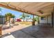 Spacious covered patio with stamped concrete and stone pillars overlooking a well landscaped yard at 7047 W Almeria Rd, Phoenix, AZ 85035