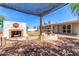 Backyard patio featuring an outdoor fireplace and ornate fountain at 7047 W Almeria Rd, Phoenix, AZ 85035