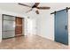 Stylish bedroom with a barn door, accent wall, and tile flooring at 7047 W Almeria Rd, Phoenix, AZ 85035