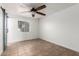 Bright bedroom featuring a ceiling fan, natural light, and neutral decor at 7047 W Almeria Rd, Phoenix, AZ 85035