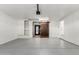 Spacious two car garage featuring a gray floor and decorative sliding barn door at 7047 W Almeria Rd, Phoenix, AZ 85035