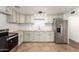 Bright kitchen featuring sleek appliances, butcher block countertops, and subway tile backsplash at 7047 W Almeria Rd, Phoenix, AZ 85035