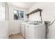 Bright laundry room with a window, shelving, and washer and dryer at 7047 W Almeria Rd, Phoenix, AZ 85035