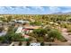 Expansive aerial shot showcasing the property's location, mature trees, pool, and stunning views of the surrounding area at 7102 E Kalil Dr, Scottsdale, AZ 85254