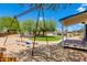 Backyard featuring a swing set, gazebo, and manicured lawn at 7102 E Kalil Dr, Scottsdale, AZ 85254