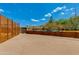 Large backyard showcasing desert landscaping enclosed by a modern fence and planter boxes at 7102 E Kalil Dr, Scottsdale, AZ 85254