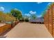 Spacious backyard featuring a boat with cover, kayak, natural desert landscaping, and a modern fence at 7102 E Kalil Dr, Scottsdale, AZ 85254