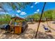 Outdoor kitchen and eating area with swing set in landscaped backyard at 7102 E Kalil Dr, Scottsdale, AZ 85254
