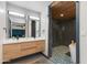 Bright bathroom featuring a modern vanity, dual mirrors, and a stylish walk-in shower with tile accents at 7102 E Kalil Dr, Scottsdale, AZ 85254