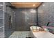 Modern bathroom showcasing a large tub and shower with stylish blue tile and wooden ceiling at 7102 E Kalil Dr, Scottsdale, AZ 85254