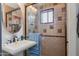 A well-lit bathroom offers a pedestal sink with a glass enclosed shower and patterned wall tile at 7102 E Kalil Dr, Scottsdale, AZ 85254