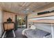 Bedroom features a bunk bed, a wood plank ceiling, and sliding glass doors to the backyard at 7102 E Kalil Dr, Scottsdale, AZ 85254