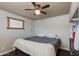 This bedroom features a ceiling fan, a window, and built-in wardrobe at 7102 E Kalil Dr, Scottsdale, AZ 85254