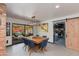 Dining room with wooden table, blue chairs, sliding barn door, and view to the outdoor living area at 7102 E Kalil Dr, Scottsdale, AZ 85254