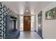 Inviting foyer with patterned accent wall, storage bench and well lit entrance at 7102 E Kalil Dr, Scottsdale, AZ 85254