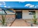 Welcoming entryway featuring desert plants and a secure ADT system, offering a blend of style and peace of mind at 7102 E Kalil Dr, Scottsdale, AZ 85254