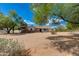 Inviting single-story residence with desert landscaping, mature trees and a well-manicured front yard at 7102 E Kalil Dr, Scottsdale, AZ 85254