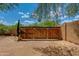 Secure backyard gate made of wood and metal at 7102 E Kalil Dr, Scottsdale, AZ 85254