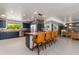 Open-concept kitchen with dark blue cabinets, butcher block countertops, and seating at the island at 7102 E Kalil Dr, Scottsdale, AZ 85254