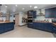 Modern kitchen with dark blue cabinets, stainless steel appliances, and a stylish backsplash at 7102 E Kalil Dr, Scottsdale, AZ 85254