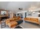 Spacious living room featuring a brick fireplace and a comfortable leather sectional sofa at 7102 E Kalil Dr, Scottsdale, AZ 85254