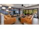 Stylish living room featuring leather couches, modern shelves and large sliding glass doors at 7102 E Kalil Dr, Scottsdale, AZ 85254