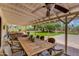 Covered patio with a large outdoor dining table and views of the backyard at 7102 E Kalil Dr, Scottsdale, AZ 85254