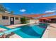 Backyard pool with a diving board and a slide with shade sails overhead at 7102 E Kalil Dr, Scottsdale, AZ 85254