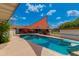 Inviting pool area with a diving board, slide, covered seating, and a sun shade at 7102 E Kalil Dr, Scottsdale, AZ 85254