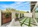 Well-manicured backyard featuring a modern design with artificial grass, stone pavers and gate at 7330 E Vista Bonita Dr, Scottsdale, AZ 85255
