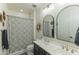 Bathroom with double vanity, modern fixtures, decorative mirrors, and tiled shower-tub combination at 7330 E Vista Bonita Dr, Scottsdale, AZ 85255