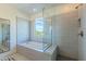 Bright bathroom with soaking tub, glass shower, and window with natural light and views of the outdoors at 7330 E Vista Bonita Dr, Scottsdale, AZ 85255