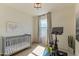Multipurpose bedroom with crib and Peleton and views of the neighborhood through window and streaming natural light at 7330 E Vista Bonita Dr, Scottsdale, AZ 85255