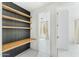Hallway featuring built-in wooden shelving, white walls and baseboards, and interior doors at 7330 E Vista Bonita Dr, Scottsdale, AZ 85255