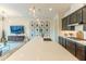 Spacious kitchen featuring a large island with seating, stylish pendant lights, and stainless steel appliances at 7330 E Vista Bonita Dr, Scottsdale, AZ 85255