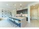 Bright kitchen featuring a large island with seating, stylish pendant lights, and stainless steel appliances at 7330 E Vista Bonita Dr, Scottsdale, AZ 85255