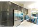 Gourmet kitchen with stainless steel refrigerator, custom cabinets and adjacent dining area at 7330 E Vista Bonita Dr, Scottsdale, AZ 85255