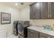 Contemporary laundry room with sleek cabinetry, modern washer and dryer, and decorative accents at 7330 E Vista Bonita Dr, Scottsdale, AZ 85255